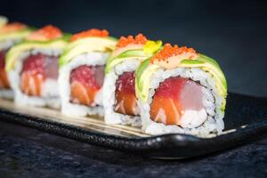 Delicious sushi rolls with avocado slices photo